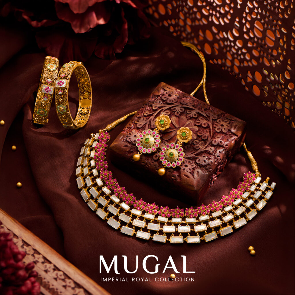 Regal Jewellers Mugal Collection jewellery set featuring a gold and ruby choker necklace, matching stud earrings with pink accents, and traditional floral gold bangles.