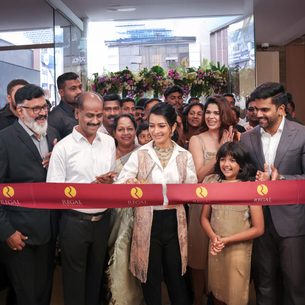 Grand inauguration of Regal Jewellers Kammanahalli showroom with brand ambassador Radhika Pandit cutting the ribbon, joined by guests, staff, and well-wishers during the opening celebration.