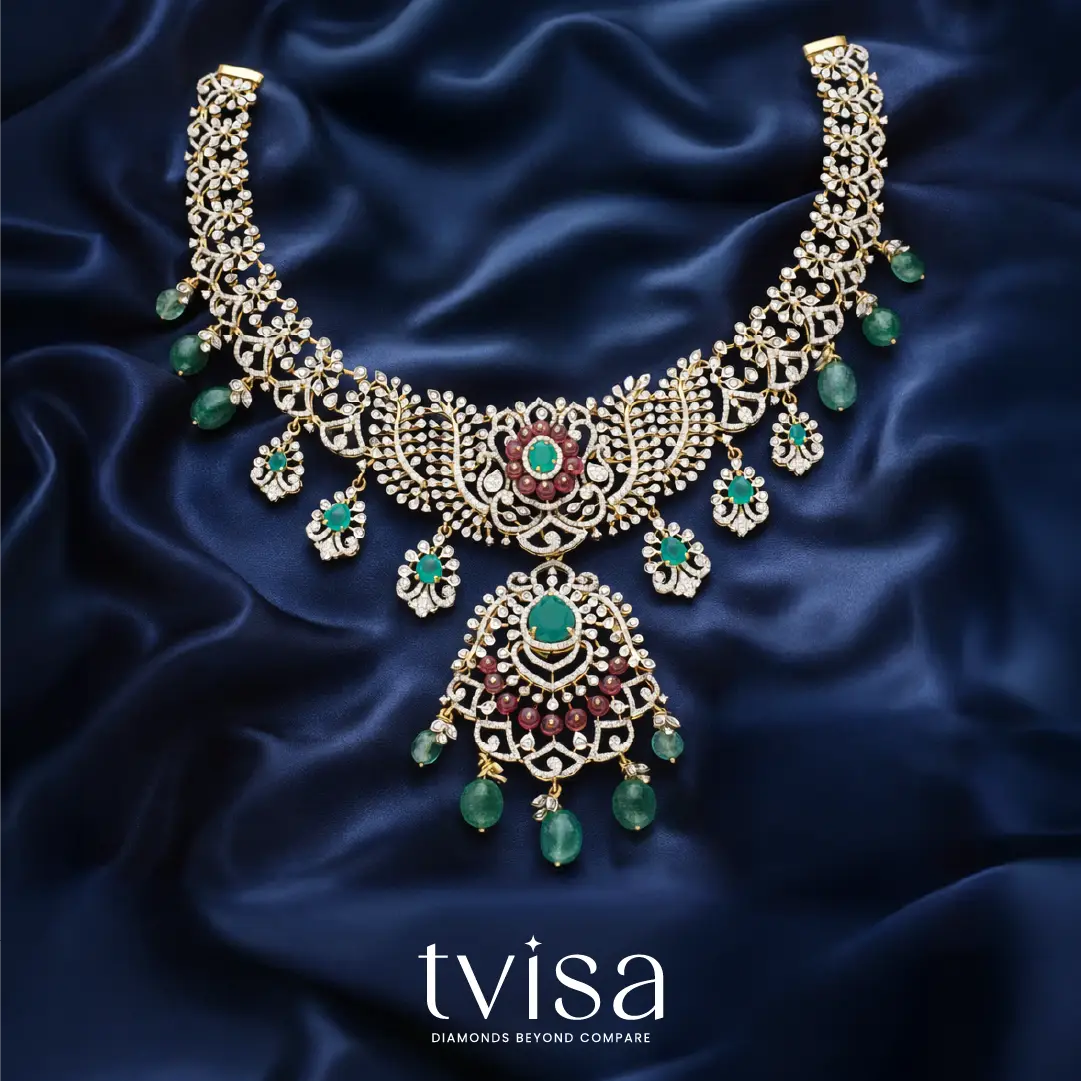 Tvisa diamond necklace with emerald green stones and intricate floral design